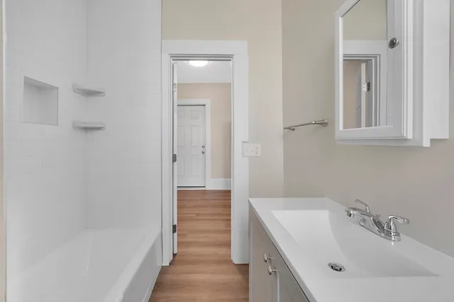 a bathroom with a sink and shower