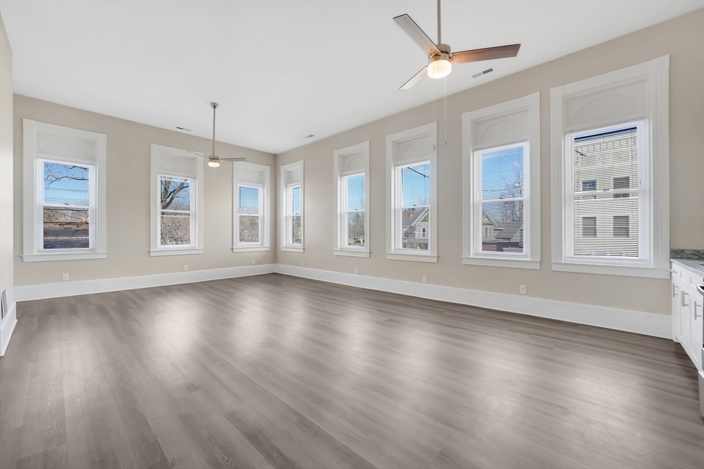 76-96 Maple Street Northampton, MA 01062 - Photo 10 of 22 a view of an empty room with wooden floor and a window