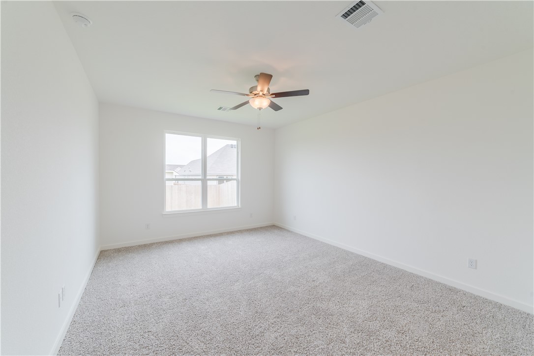 1901 Sebright Drive Bryan, TX 77807 - Photo 7 of 13 an empty room with a window and a ceiling fan