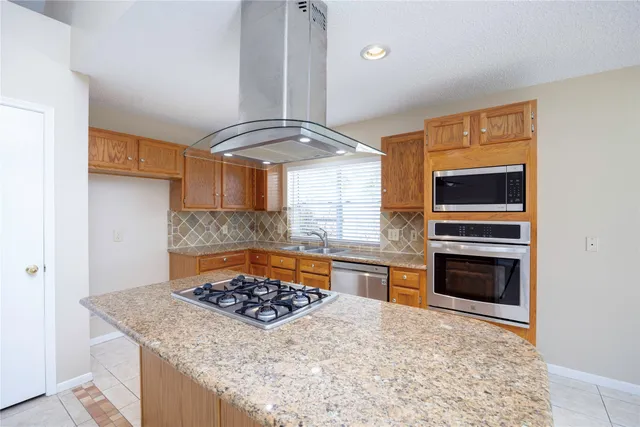 a kitchen with a stove a sink and a refrigerator