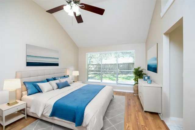 a spacious bedroom with a bed and a large window