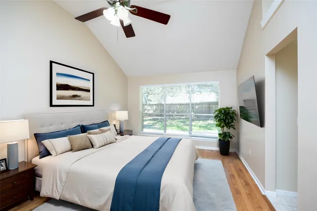 a large bedroom with a large bed and a large window