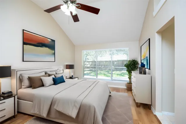 a bedroom with a large bed and a window