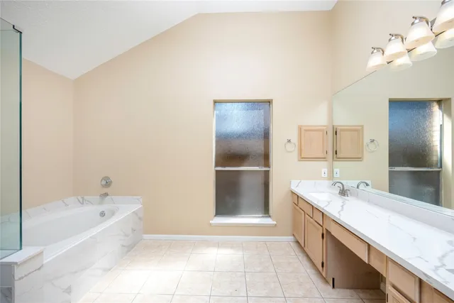 a large spacious bathroom with a bathtub and a sink
