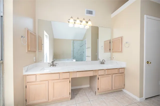 a bathroom with a sink double vanity and a mirror