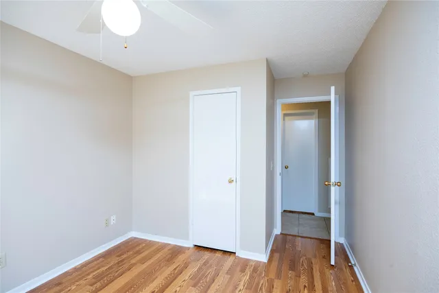 a view of a room with wooden floor and a bathroom