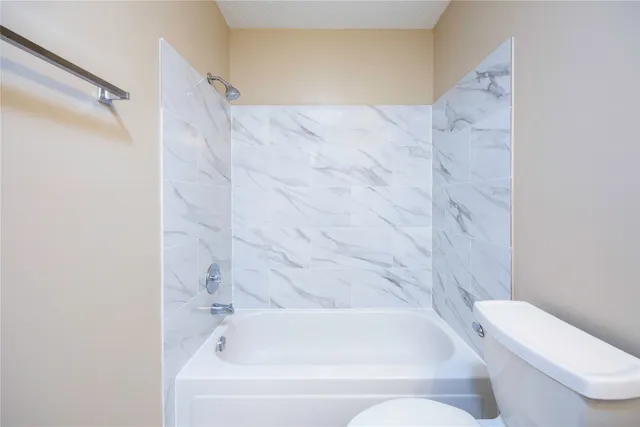 a bathroom with a bathtub and toilet