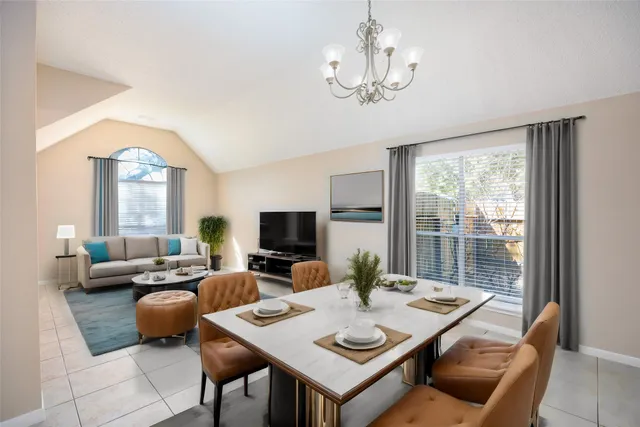 a living room with furniture a flat screen tv and a large window