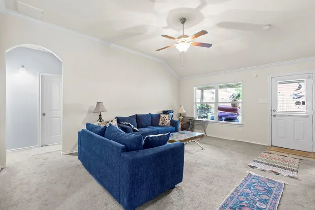 a living room with furniture and a chandelier