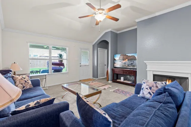 a living room with furniture and a fireplace