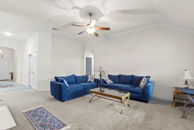 a living room with furniture and a chandelier