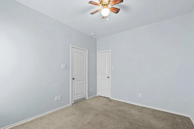 an empty room with a fan