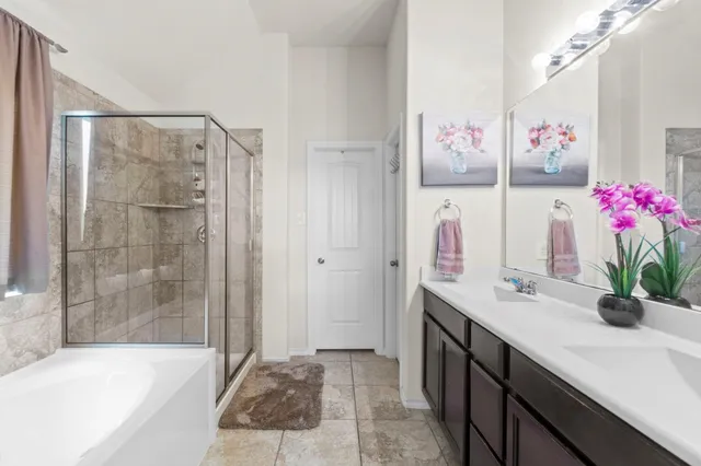 a bathroom with a tub sink and mirror