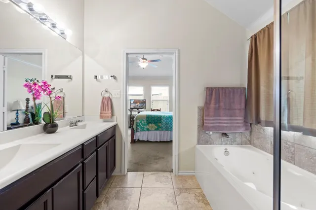 a bathroom with a bathtub sink and mirror