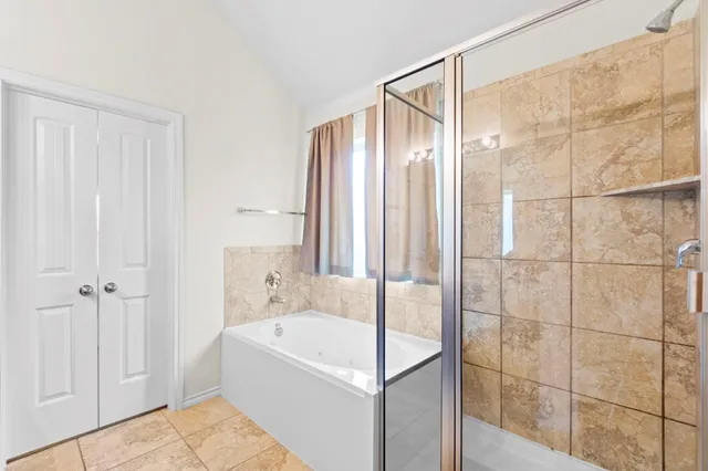 a bathroom with a bathtub and shower
