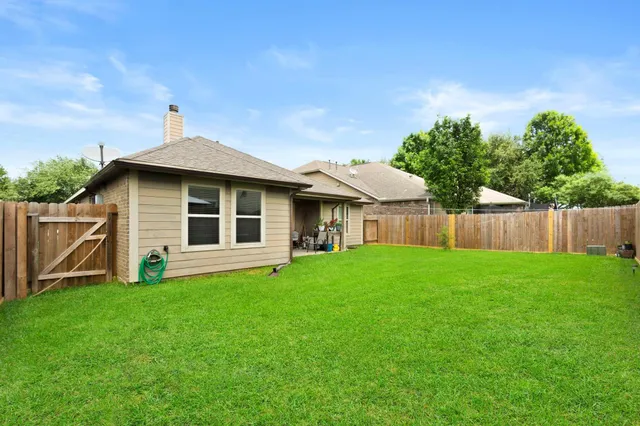 a front view of a house with yard and green space