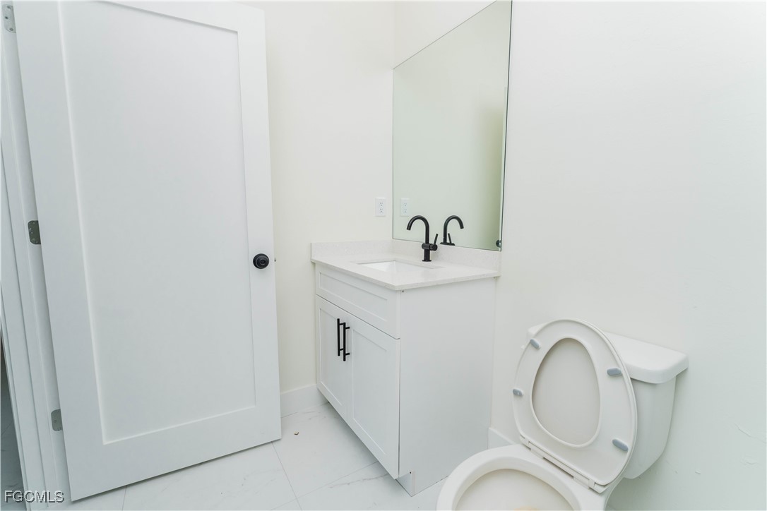 1171 Countess Avenue Lehigh Acres, FL 33974 - Photo 13 of 15 a bathroom with a sink and a mirror