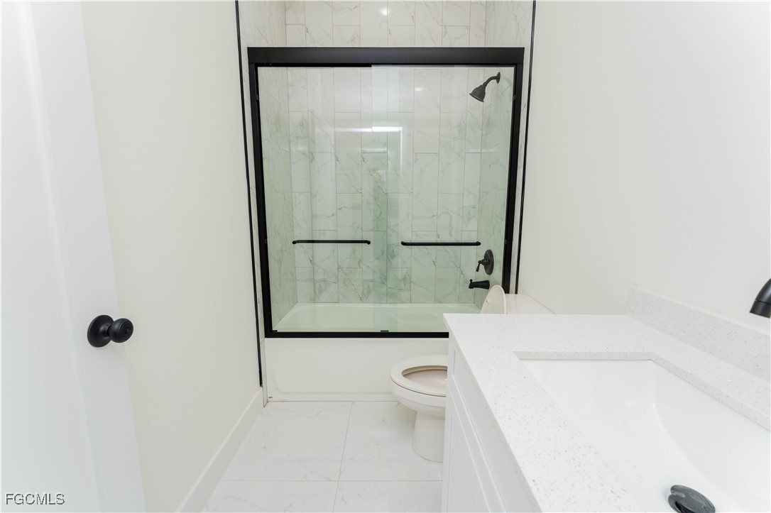 1171 Countess Avenue Lehigh Acres, FL 33974 - Photo 9 of 15 a bathroom with a granite countertop sink mirror vanity and toilet