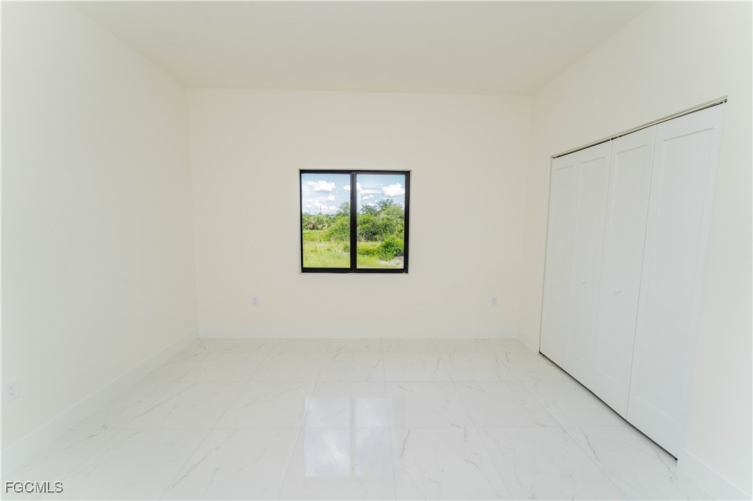 1171 Countess Avenue Lehigh Acres, FL 33974 - Photo 10 of 15 an empty room with windows