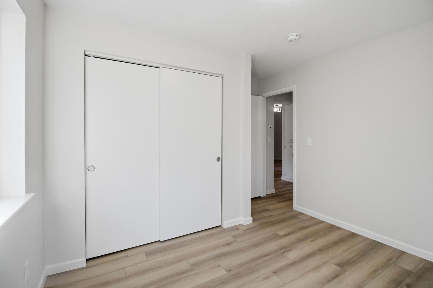19088 Hillhaven Road Tuolumne, CA 95379 - Photo 14 of 27 a view of an empty room with wooden floor and closet