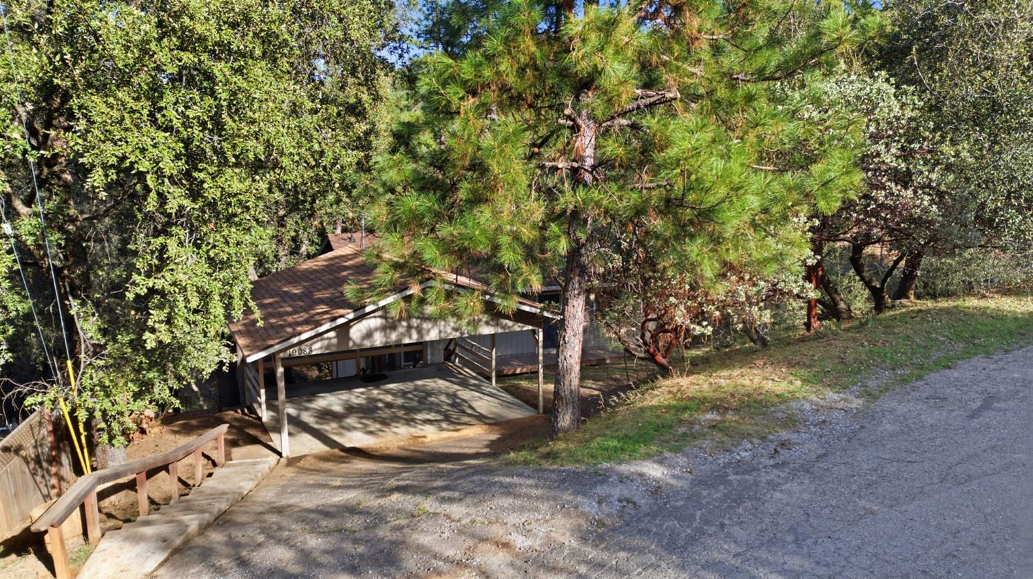 19088 Hillhaven Road Tuolumne, CA 95379 - Photo 22 of 27 a view of a wooden house with a tree
