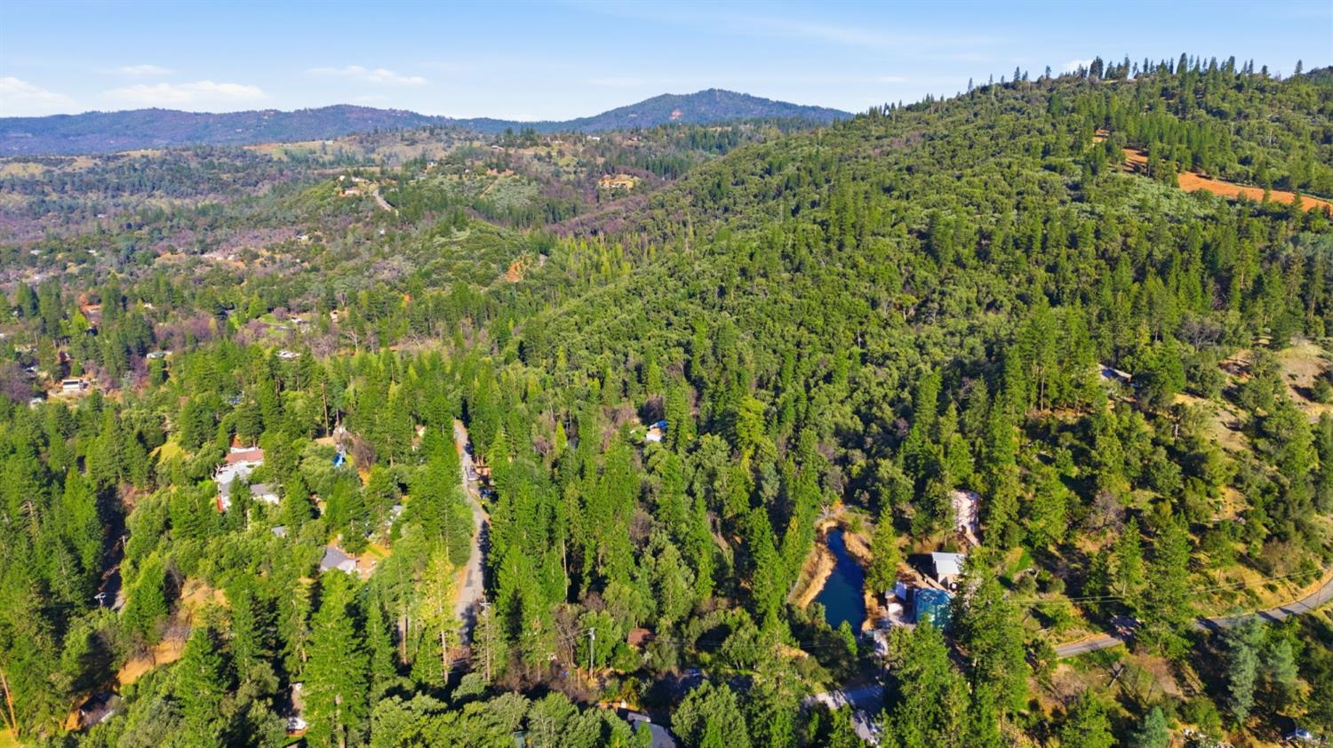 19088 Hillhaven Road Tuolumne, CA 95379 - Photo 25 of 27 a view of a lush green hillside and a mountain