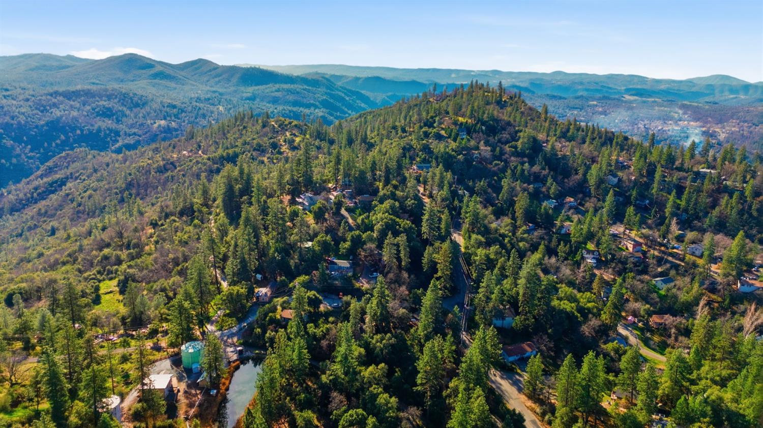 19088 Hillhaven Road Tuolumne, CA 95379 - Photo 26 of 27 a view of a lush green forest with mountains in the background