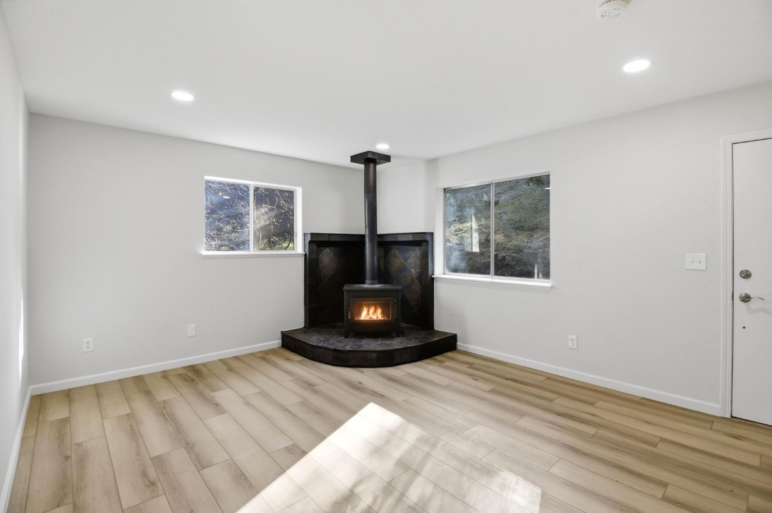 19088 Hillhaven Road Tuolumne, CA 95379 - Photo 5 of 27 a living room with a fireplace and a window