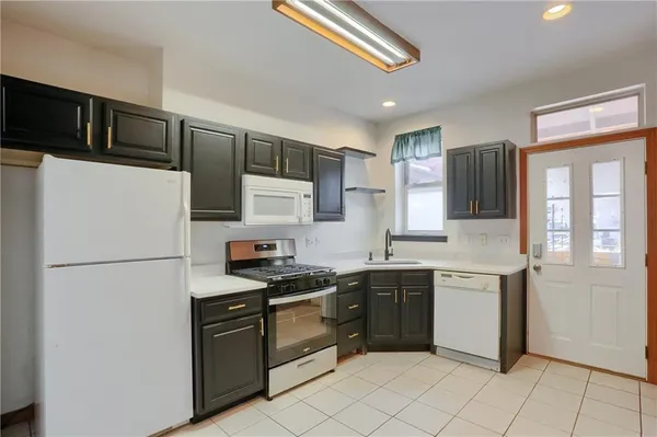 a view of a kitchen with a table and chairs