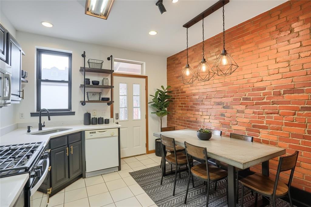 2810 Sarah Street, Unit 2 Pittsburgh, PA 15203 - Photo 12 of 27 a view of a kitchen with a table and chairs