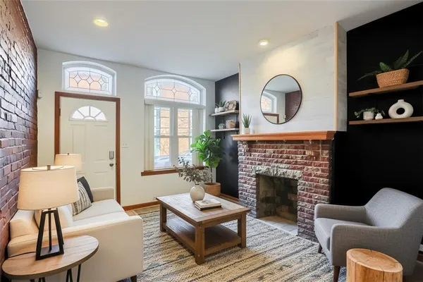 a living room with furniture a fireplace and a flat screen tv
