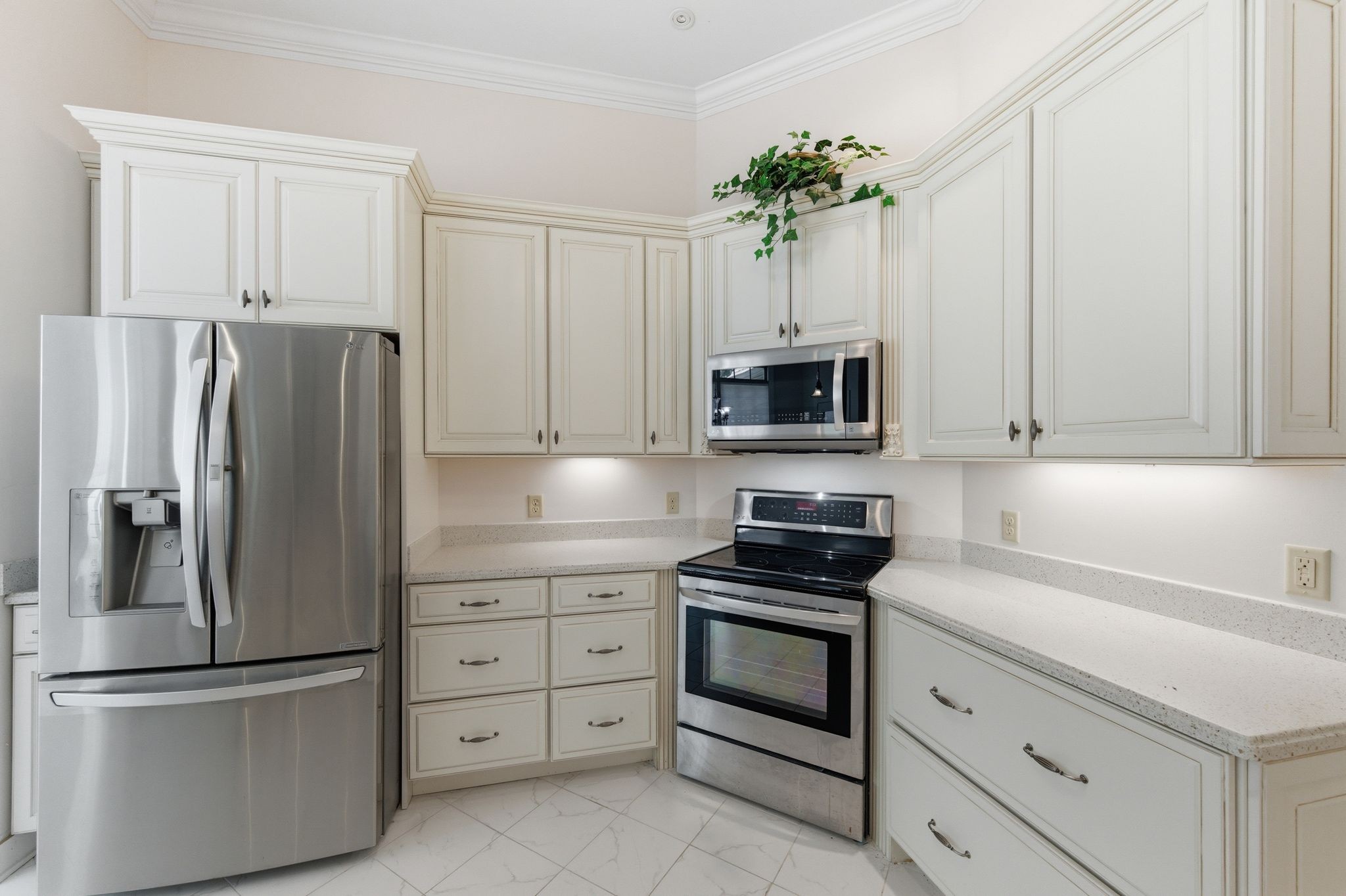 528 Country Club Drive Dickson, TN 37055 - Photo 21 of 55 a kitchen with white cabinets and stainless steel appliances