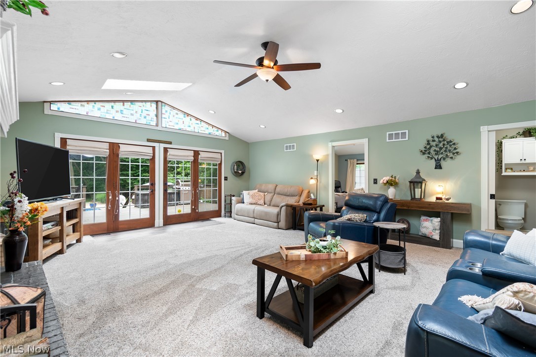 443 Merriman Road Akron, OH 44303 - Photo 14 of 44 Vaulted ceiling great room featuring wood-finish glass panel French doors, a skylight, and recessed lighting