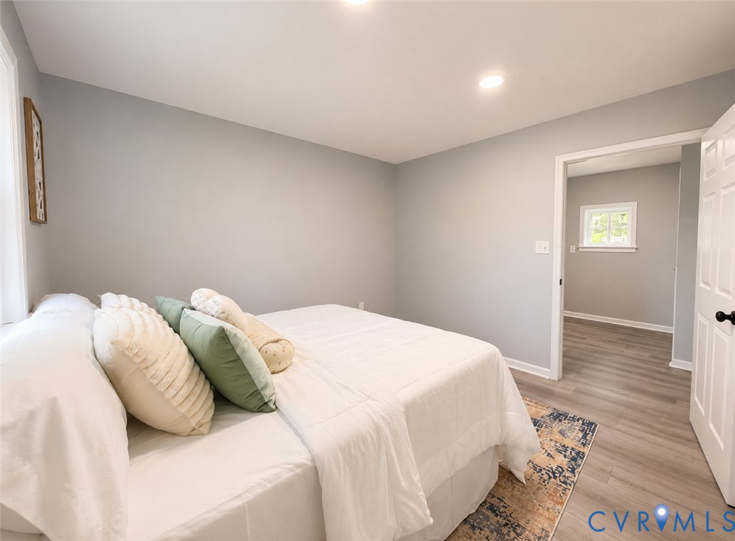 110 Locust Grove Cartersville, VA 23027 - Photo 10 of 26 a bedroom with a bed and wooden floor
