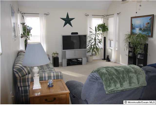 615 Thoroughfare Road Brick, NJ 08724 - Photo 2 of 3 a living room with furniture and a flat screen tv