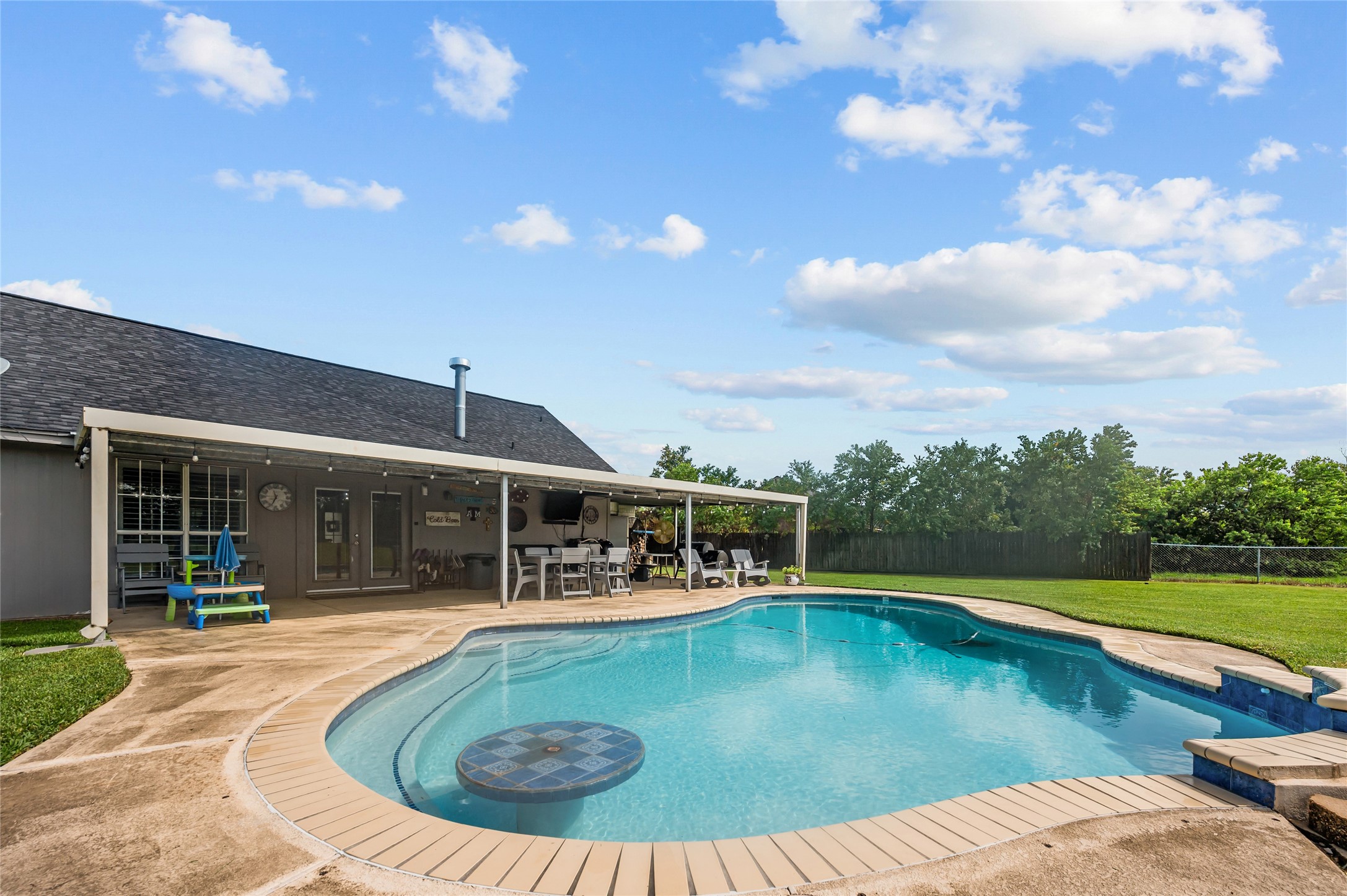 4602 Joe Patch Road Cove, TX 77523 - Photo 35 of 40 The spacious, covered patio stretches the length of the house with full views of the back yard and pool.