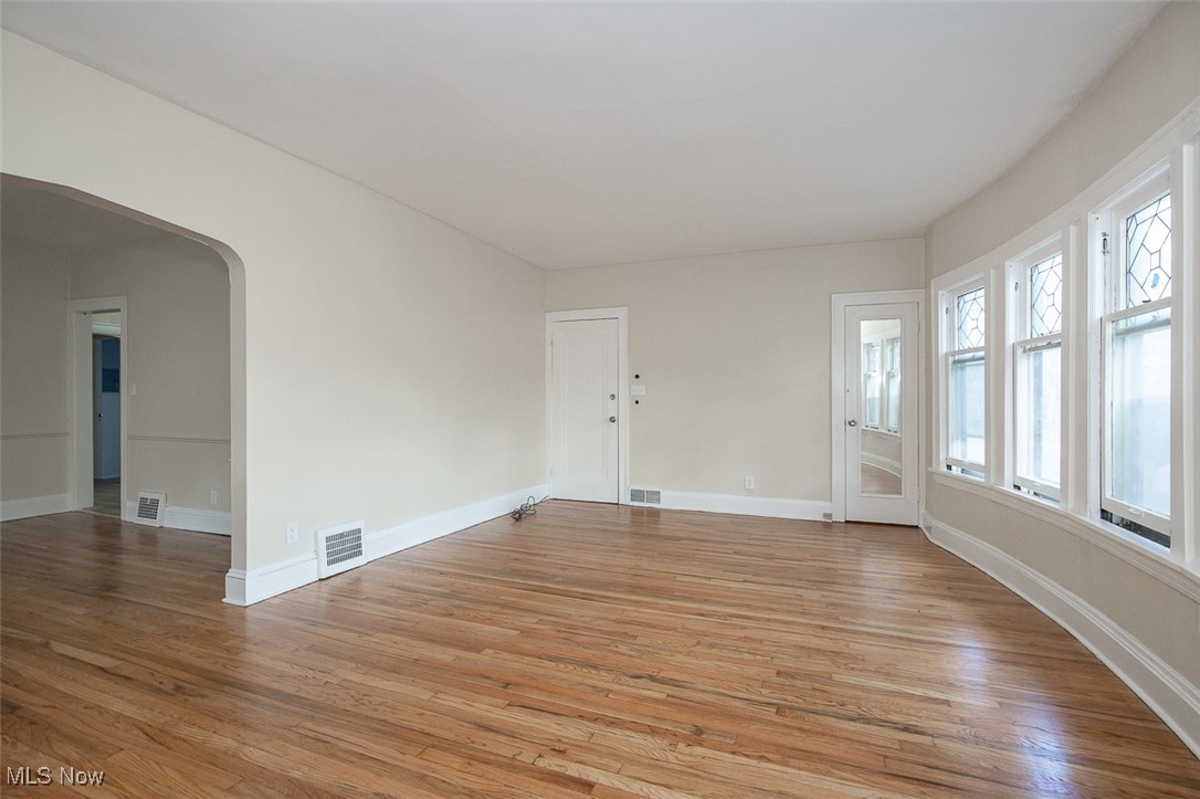 3616 Hildana Road Cleveland, OH 44120 - Photo 11 of 27 Unfurnished room with arched walkways and light wood-style flooring