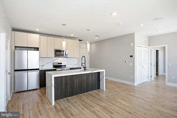 a kitchen with a sink a stove and cabinets