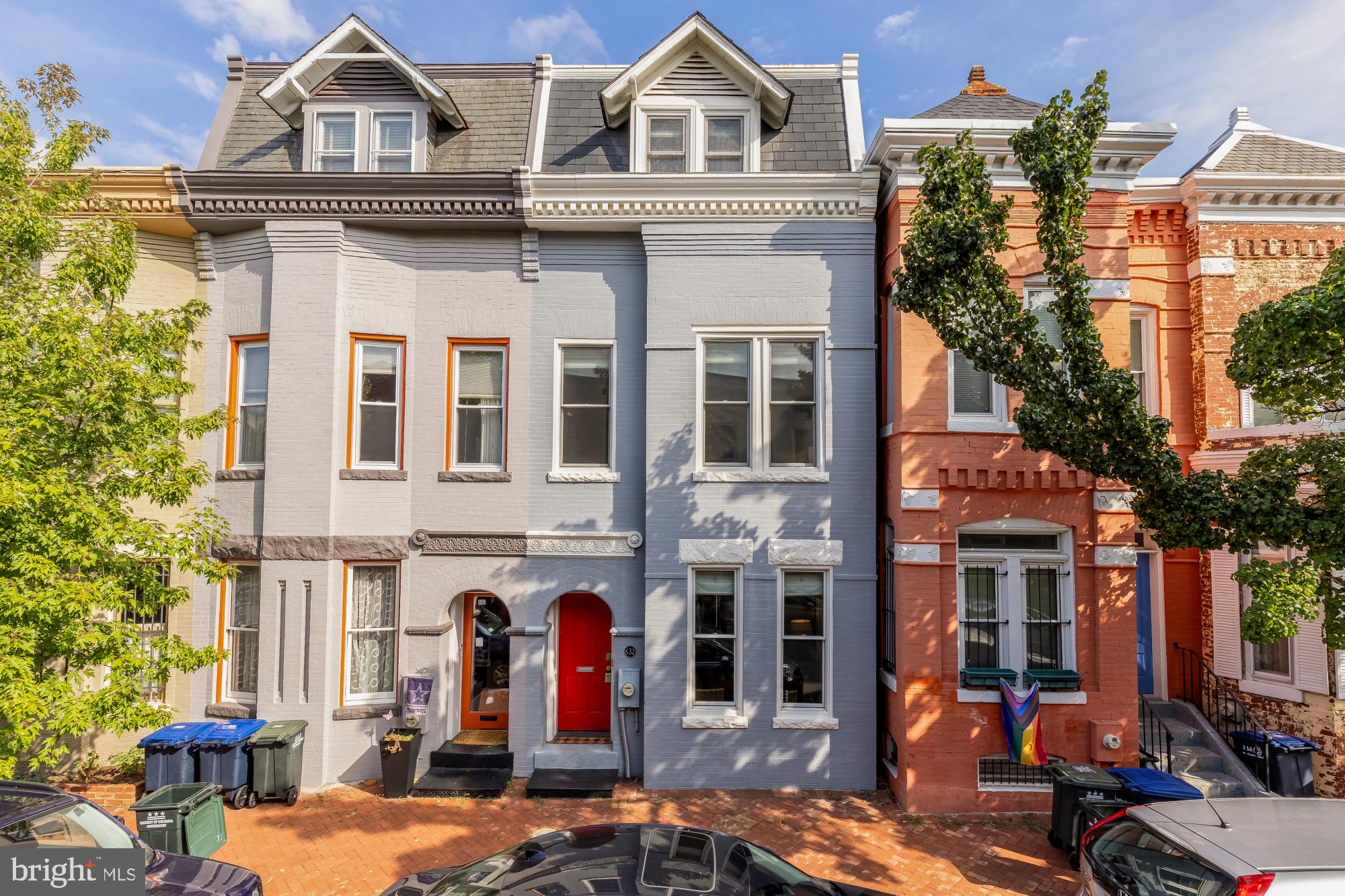 a front view of a residential apartment building with a yard
