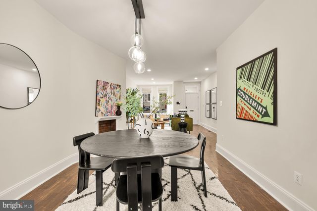 a view of a dining room with furniture and a mirror