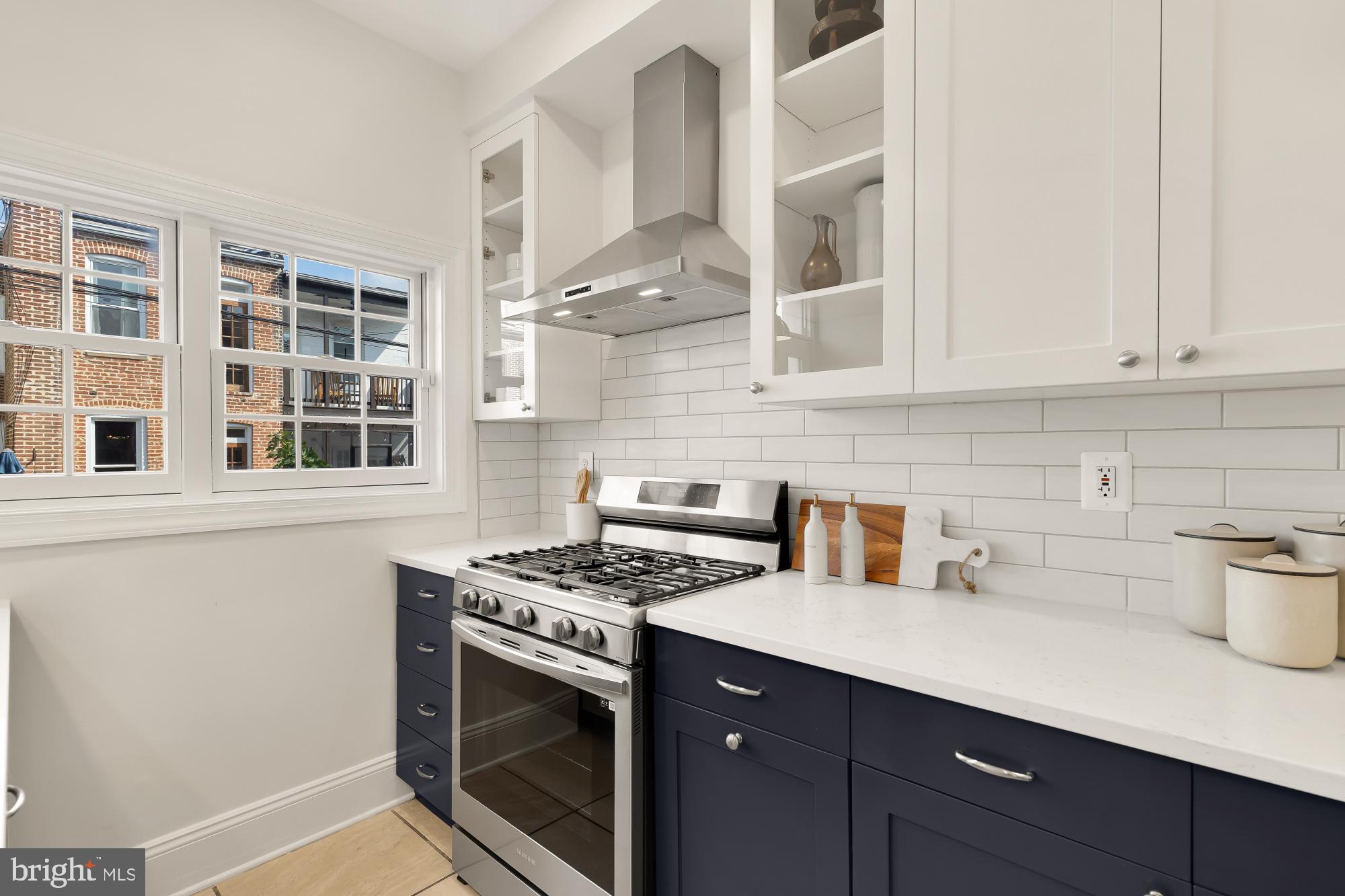 632 Acker Place Northeast Washington, DC 20002 - Photo 15 of 57 a kitchen with stainless steel appliances granite countertop a stove a sink and a microwave