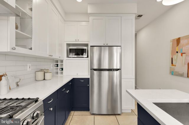 a kitchen with a refrigerator and a sink