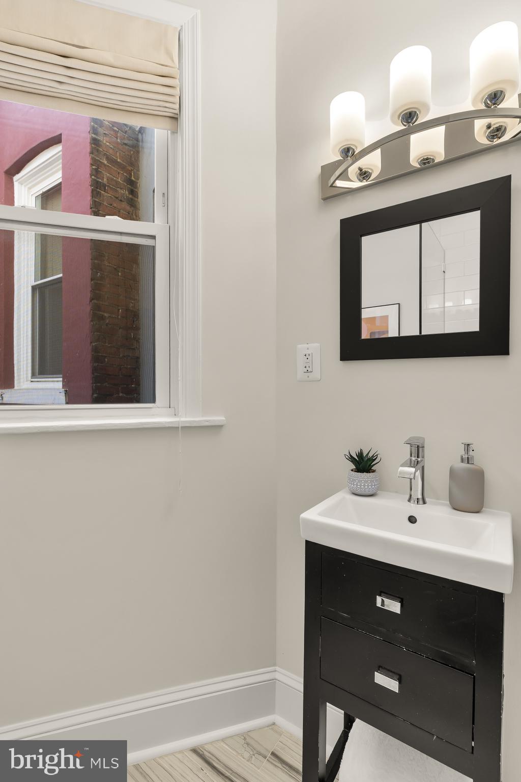 632 Acker Place Northeast Washington, DC 20002 - Photo 25 of 57 a bathroom with a sink vanity and a mirror