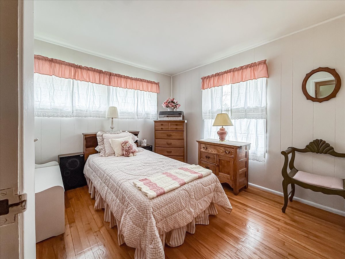 1612 Cornell Drive Champaign, IL 61821 - Photo 16 of 28 a bedroom with a bed and a table in it with wooden floor