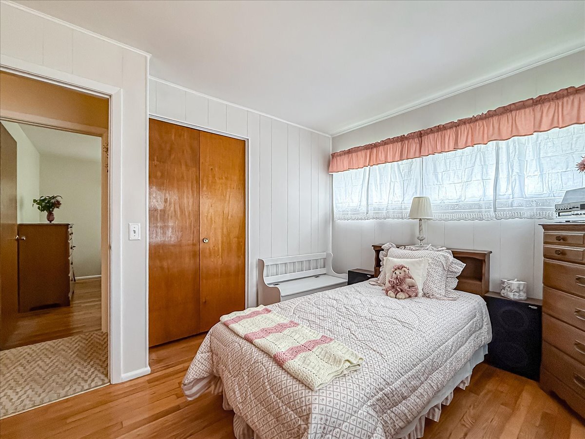 1612 Cornell Drive Champaign, IL 61821 - Photo 17 of 28 a bedroom with a bed and wooden floor