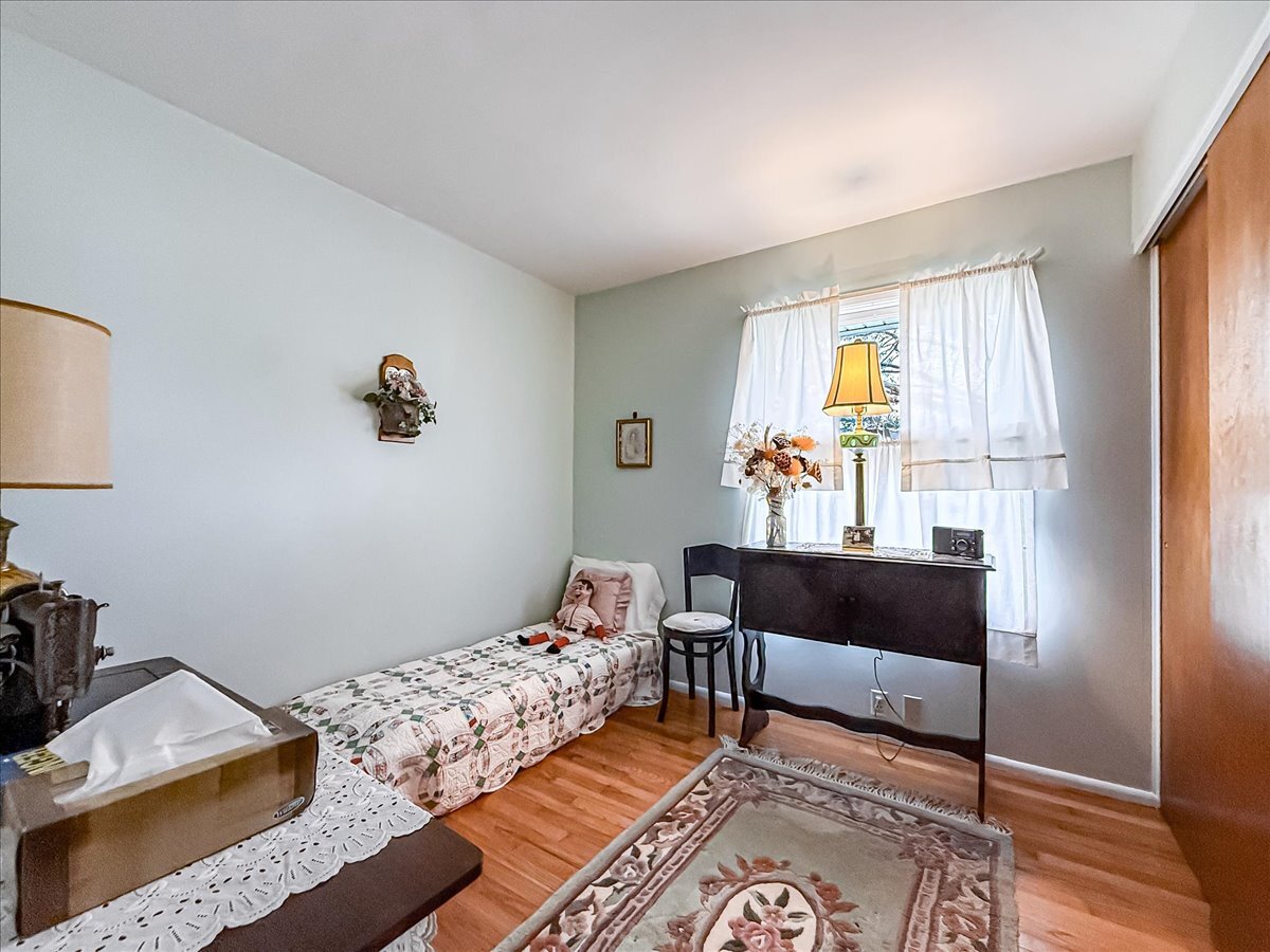 1612 Cornell Drive Champaign, IL 61821 - Photo 19 of 28 a bedroom with a bed and wooden floor