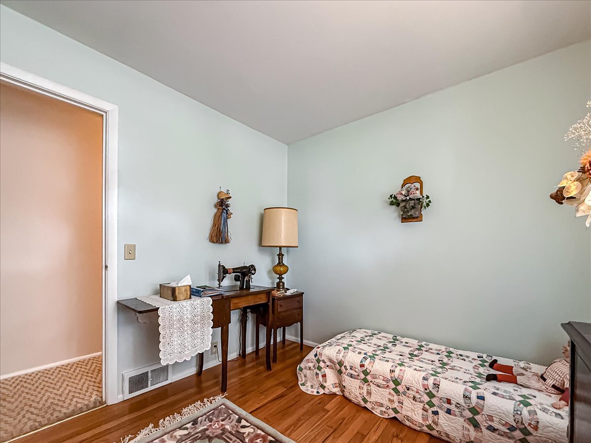 1612 Cornell Drive Champaign, IL 61821 - Photo 20 of 28 a bedroom with a bed and wooden floor