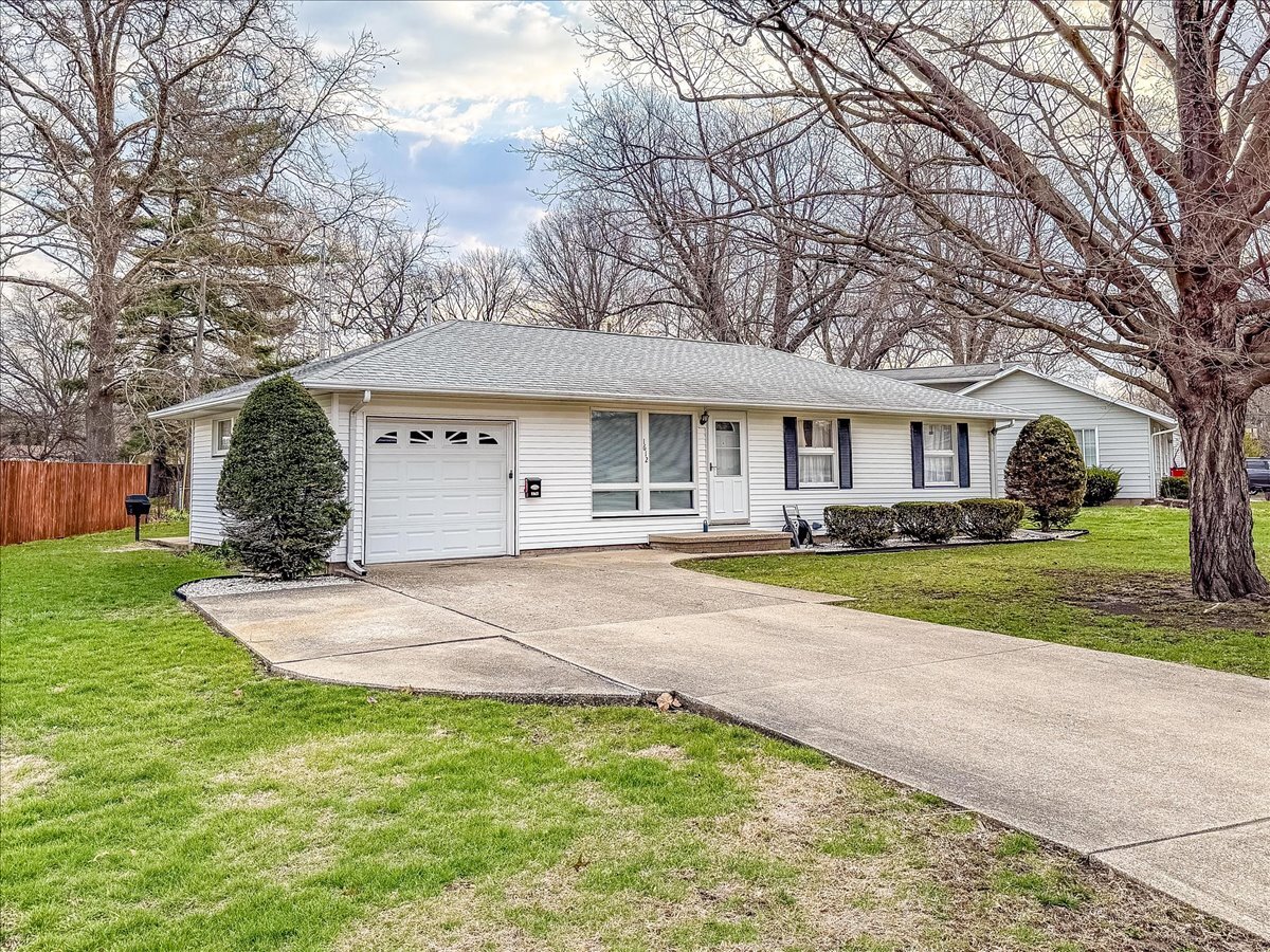 1612 Cornell Drive Champaign, IL 61821 - Photo 2 of 28 a view of a white house with a big yard and large trees