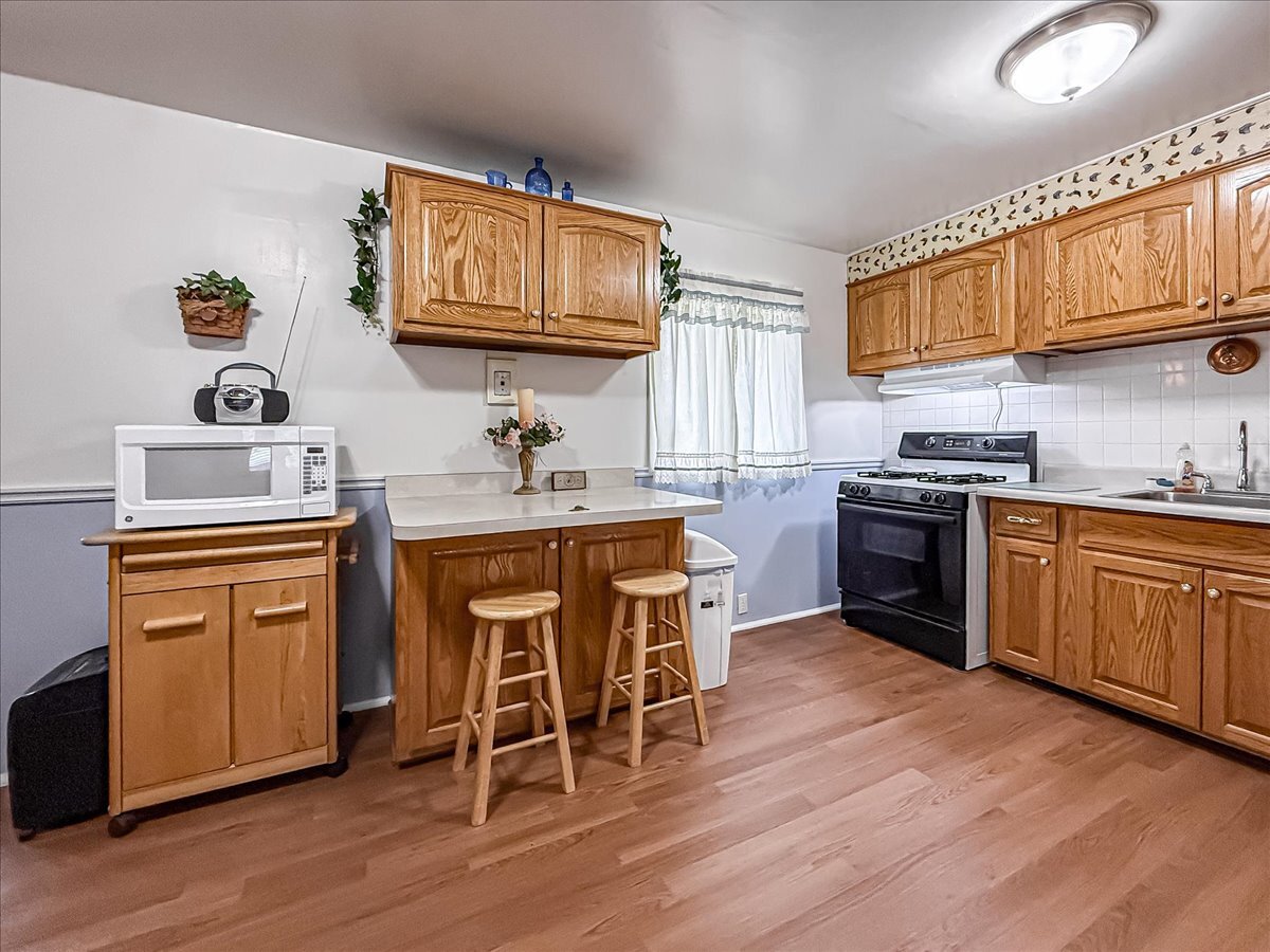 1612 Cornell Drive Champaign, IL 61821 - Photo 7 of 28 a kitchen with a sink cabinets and wooden floor