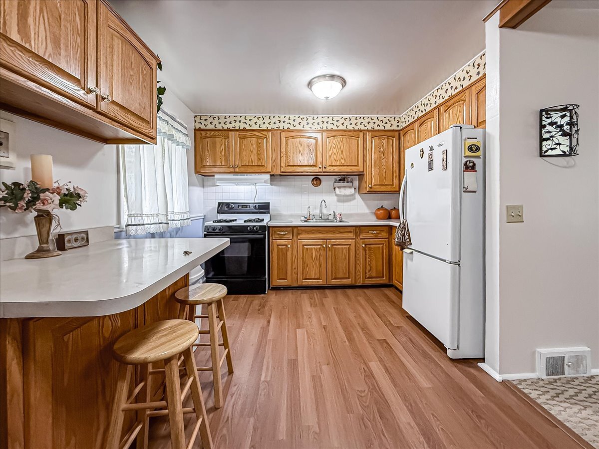 1612 Cornell Drive Champaign, IL 61821 - Photo 8 of 28 a kitchen with granite countertop a sink appliances a counter space and cabinets